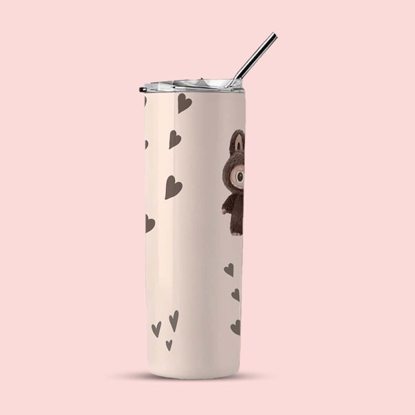 Side view of a light cream tumbler with a partial view of a brown bunny character and scattered brown hearts.