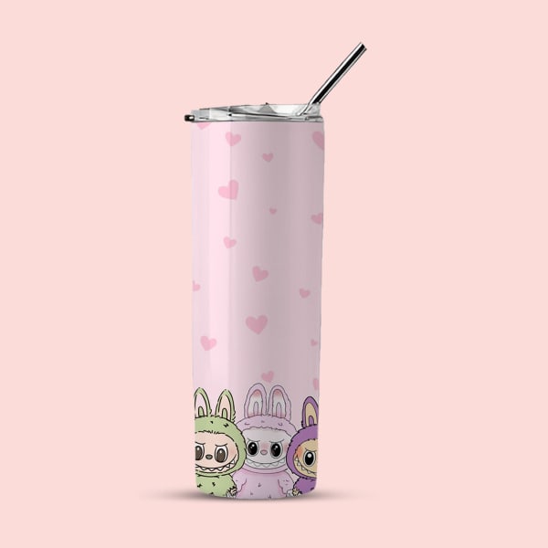 A pink tumbler with small pink hearts and three monsters (green, pink, and purple in bunny suits) at the bottom, shown with a lid and straw against a light pink background.