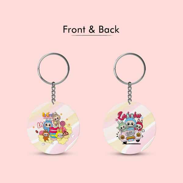 A top-down view of a circular, double-sided keychain featuring the Labubu characters on a sweet-themed background. The image highlights the keychain's 6.5cm diameter with a measurement graphic.