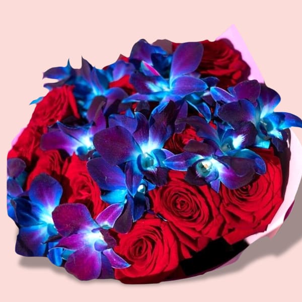 A vibrant bouquet featuring 15 deep red roses and 5 striking blue dendrobium orchids, wrapped in light pink paper.
