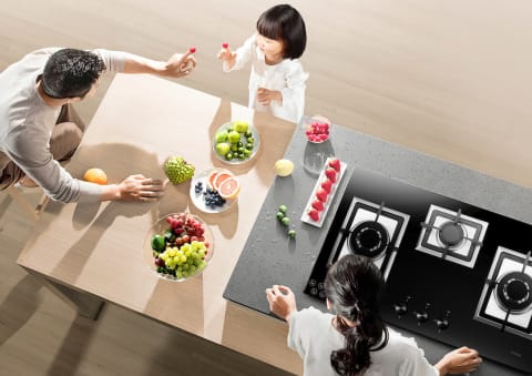 This is a family having fun and fotile cooktop