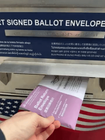 Dropping my early voting ballot into an official ballot drop box.