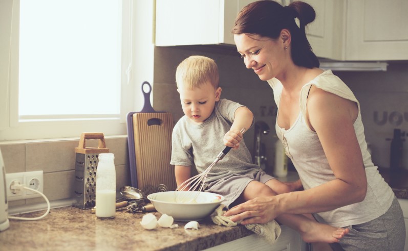 Mother with child cooking together