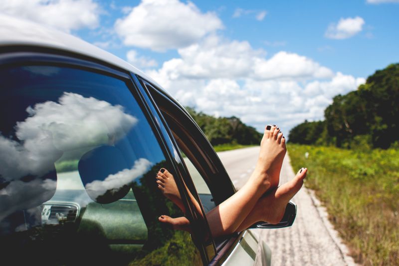 Pair of feet sticking out of a car window