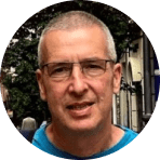 face with glasses, man with short hair in urban setting