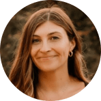 smiling woman with long brown hair and earrings against a natural background, portrait of a young woman with a warm smile