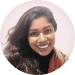 smiling woman with long, wavy hair wearing a black top and scarf, circular portrait with soft background color