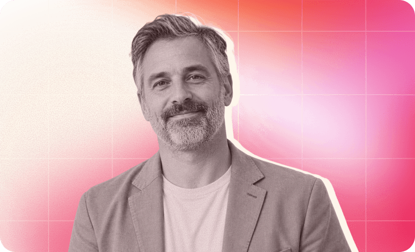 smiling man in blazer with gray hair against gradient pink background, portrait of confident professional male in casual attire