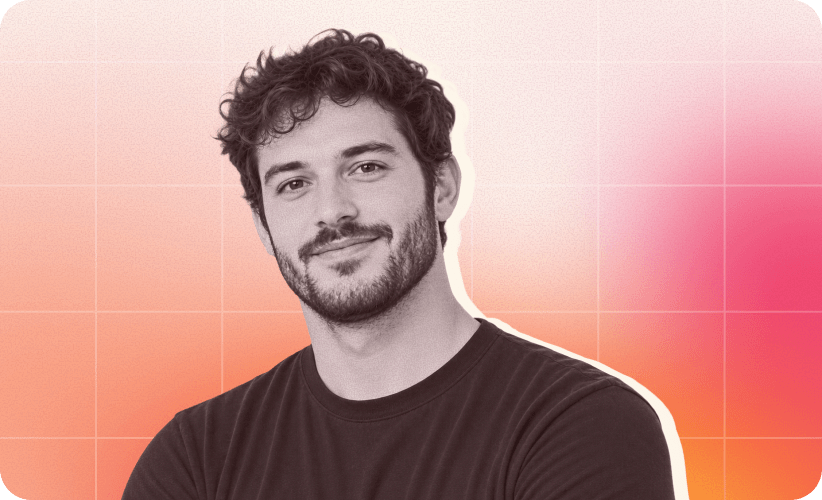 smiling man with curly hair against a gradient background; wearing a black shirt, presents a friendly demeanor, portrait of a young man in a casual setting
