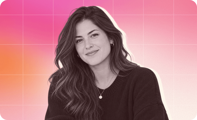 smiling woman in a black sweater against a pink gradient background, portrait with wavy hair and casual jewelry