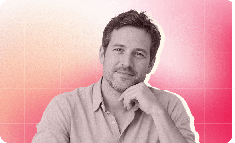 man with short hair and beard in a light shirt, smiling thoughtfully against a gradient pink background, thoughtful man portrait image