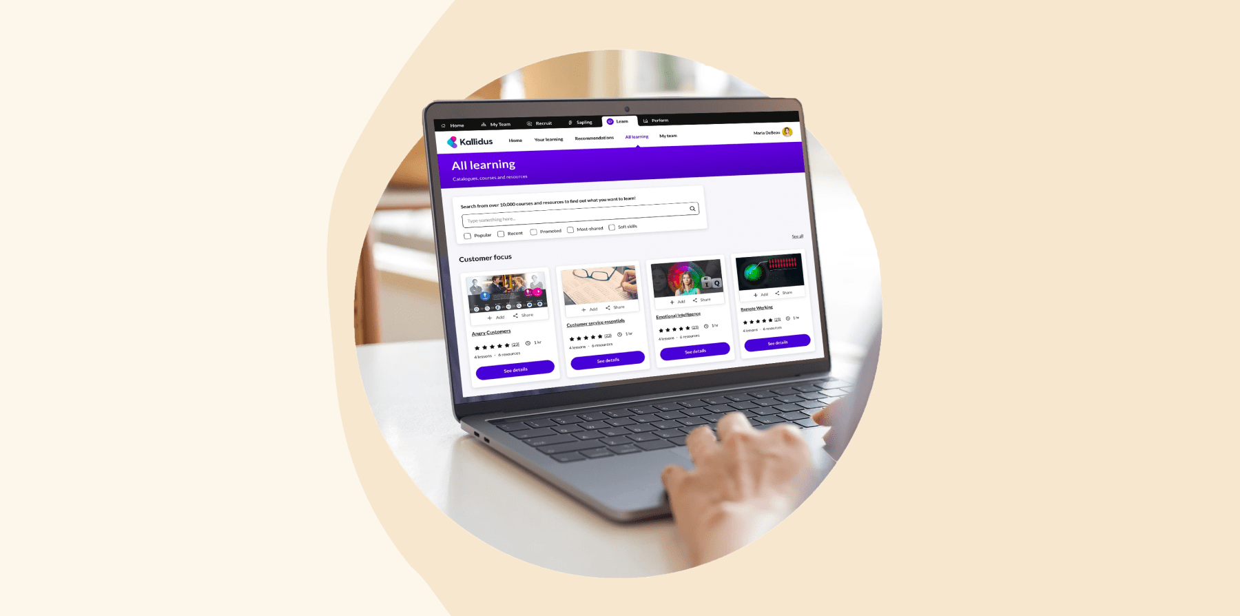 laptop displaying Kallidus learning platform with course thumbnails and search bar, focused on online learning resources, user browsing educational courses on Kallidus platform with highlighted customer focus features