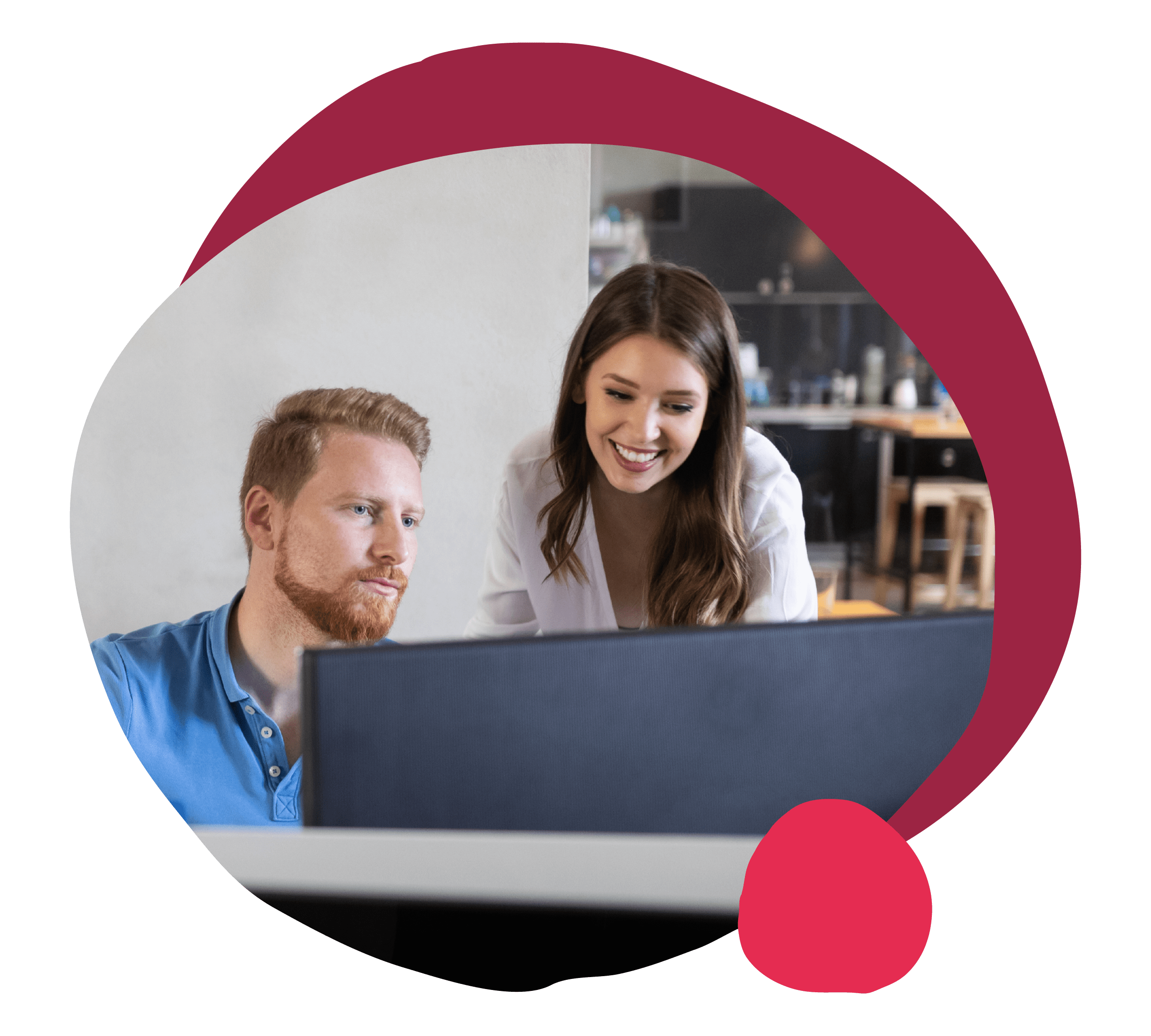 people collaborating in a modern workspace, smiling woman showing insights to focused man on computer screen