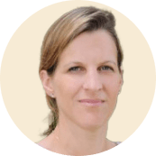 portrait of a woman with light brown hair and a neutral expression against a pale background, female professional headshot