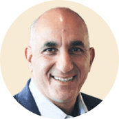 smiling man in a round frame wearing a suit against a light background, professional portrait with a welcoming expression