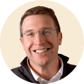 happy man with glasses smiling, portrait of a man in a round frame wearing a dark jacket