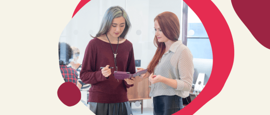 collaborative workspace, young professionals discussing ideas on a tablet in a modern office setting