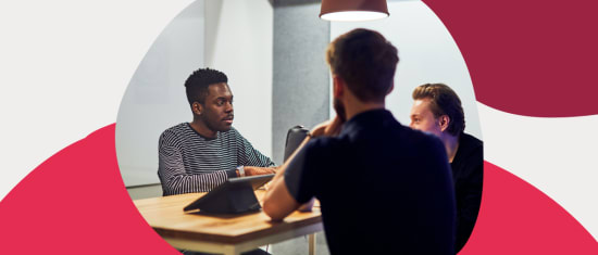 collaborative business meeting with diverse participants discussing ideas, modern workspace with warm lighting and casual attire