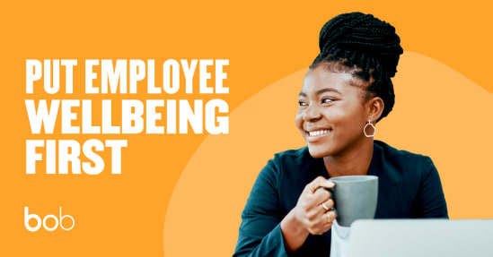 employee wellbeing focus, smiling woman with coffee in casual workspace