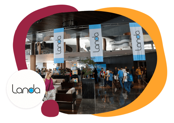 Landa banners in a busy lobby with attendees and modern decor creating a vibrant atmosphere, Landa event registration area