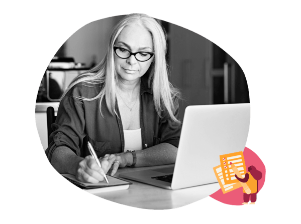 woman writing notes, laptop workspace focus
