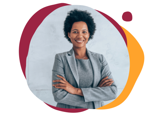 professional woman in tailored gray suit with arms crossed, smiling against a light backdrop with colorful shapes, confident businesswoman with curly hair, showcasing modern attire and positive demeanor