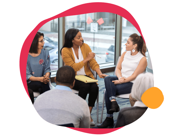 diverse group discussion, women engaging in conversation during a meeting