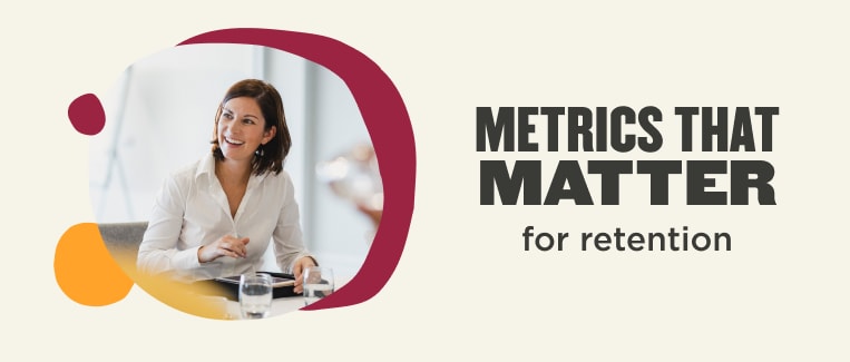 metrics that matter for retention, woman smiling with charts and glasses on table in a modern office setting