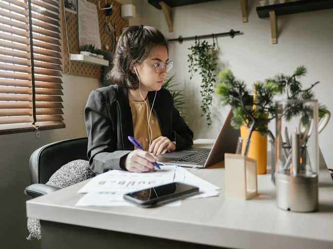 Accounting student working at desk on laptop