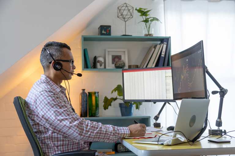 Man working on spreadsheets and graphs on a computer