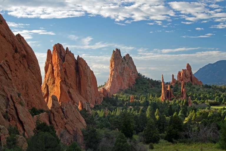 Blue skies with clouds over rock formations in Garden of the Gods in Colorado Springs, Colorado.