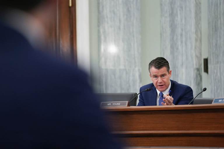 WASHINGTON, DC - JANUARY 21: Senator Todd Young, a Republican from Indiana, speaks as Pete Buttigieg, U.S. secretary of transportation nominee for U.S. President Joe Biden, left, listens during a Senate Commerce, Science and Transportation Committee confirmation hearing on January 21, 2021 in Washington, D.C. Buttigieg, is pledging to carry out the administration’s ambitious agenda to rebuild the nation’s infrastructure, calling it a “generational opportunity” to create new jobs, fight economic inequality and stem climate change.