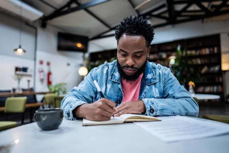 Person writing in notebook