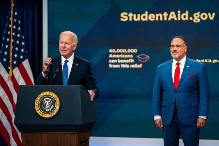 WASHINGTON, DC October 17, 2022: US President Joe Biden delivers an update on the Student Debt Relief Portal Beta Test in the South Court Auditorium of Eisenhower Executive Office Building on Monday, October 17, 2022. United States Secretary of Education Miguel Cardona was in attendance. (Photo by Demetrius Freeman/The Washington Post via Getty Images)