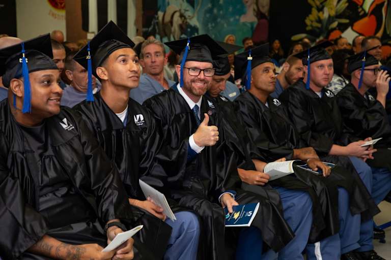 Larry "Eddie" Fordham smiling for the camera at his graduation ceremony at the Everglades Correctional Institution.