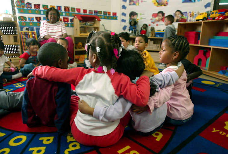Children (ages 35 y]ears old) who are participating in the Head Start Program at the Kedren Community Health Center in Watts link arms before they go outside for recess on 1/30/03. The Center is part of the Head Start Program and a Bush administration plan to give standardized reading and math test to 500,000 lowincome preschooler belonging to the national Head Start program has been met with deep skepticism. The 1/2 billion dollar program serves 900,000 children nationwide, 60% of whom are four year olds that are targeted for the test. KIDS DURING THE HEAD START PROGRAM ARE PHOTOGRAPHED ON 1/30/03. (Photo by Gary Friedman/Los Angeles Times via Getty Images)