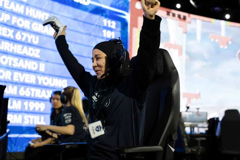 Cheerful female gamer won online video game while playing at eSports arena