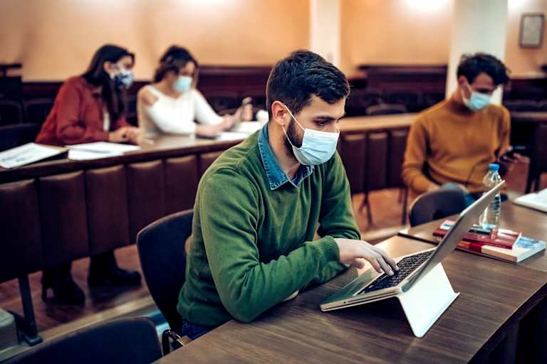 Photo of students in university class wearing masks in class.