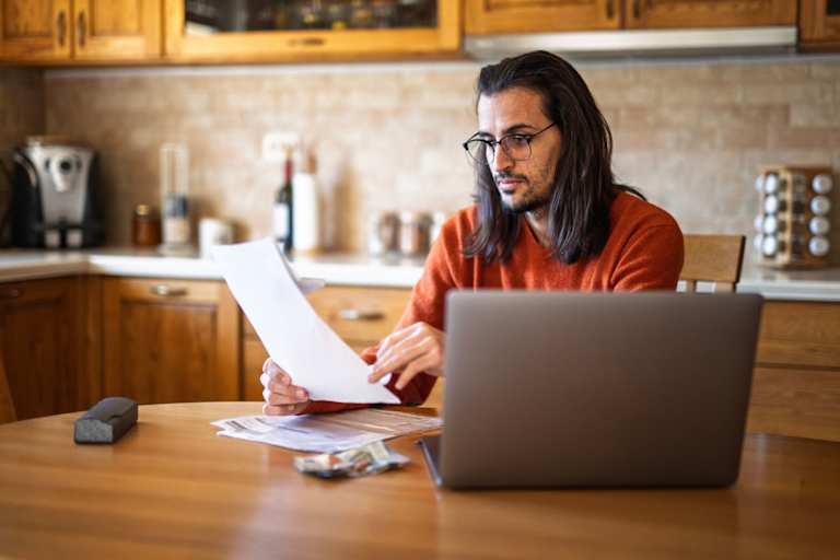 Student working on laptop at home