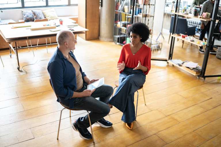 Psychologist and patient talking in modern office space