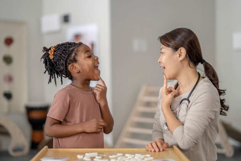 Speech therapist helping child with form