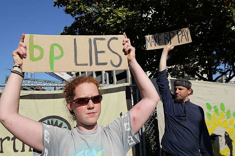 BERKELEY, CA - MAY 14: Protestors hold signs during a demonstration outside of a building that is being constructed on the U.C. Berkeley campus and is funded by British Petroleum May 14, 2010 in Berkeley, California. Dozens of protestors from San Francisco Bay Area environmental groups held a demonstration in response to the April 20 Deepwater Horizon drilling rig explosion and resulting massive oil spill in the Gulf of Mexico. (Photo by Justin Sullivan/Getty Images)