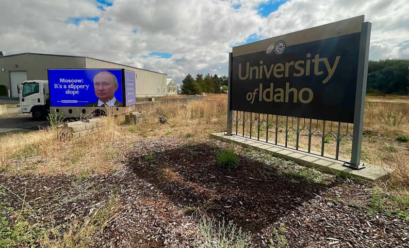 A billboard, created by health-education nonprofit Mayday Health, standing next to the University of Idaho's campus entrance sign in Moscow, Idaho. The billboard shows a picture of Russian President Vladimir Putin with the message, "Moscow: It's a slippery slope," a targeted response to the university's recent abortion and birth control restrictions.