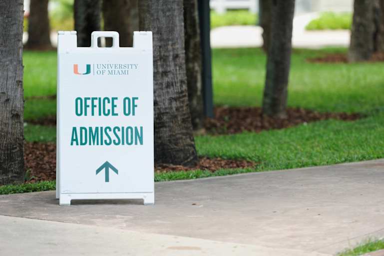 Campus sign directing students to the University of Miami Office of Admissions in Miami, Florida.