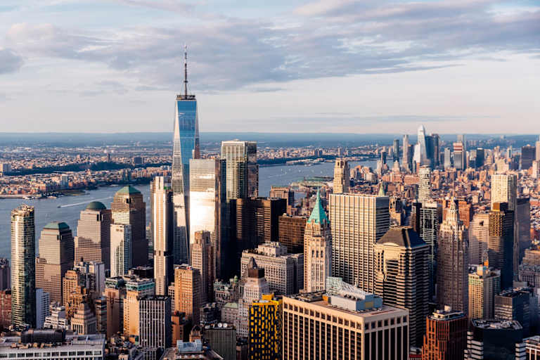 Aerial view over downtown New York City at sunset.