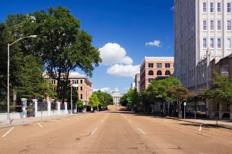 Streets on downtown Jackson, Mississippi. The historic State Capitol building can be seen in the distance at the end of the road.