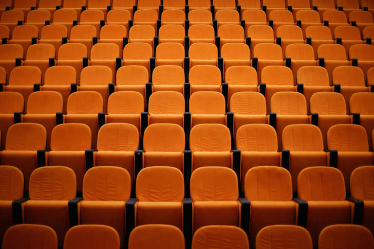Empty seats in a college lecture hall.
