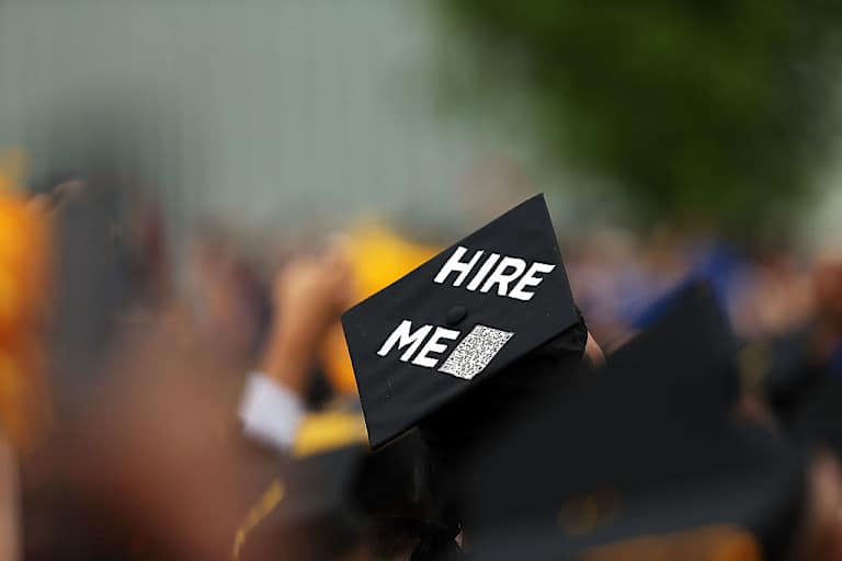 A graduating student's cap declares their future intentions during commencement exercises at City College