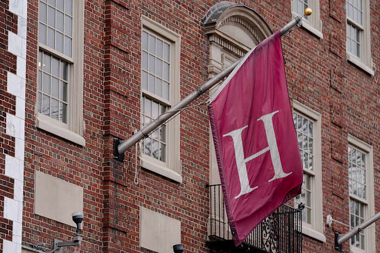 A Harvard University flag above a campus store in Cambridge, Massachusetts
