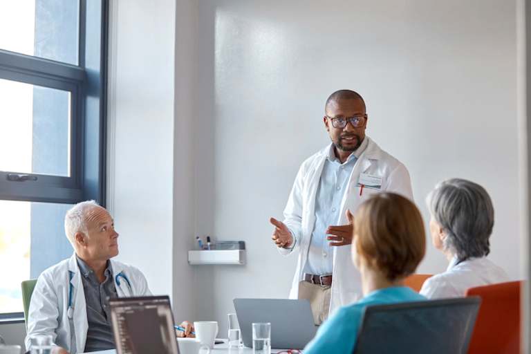 Medical expert giving presentation during meeting